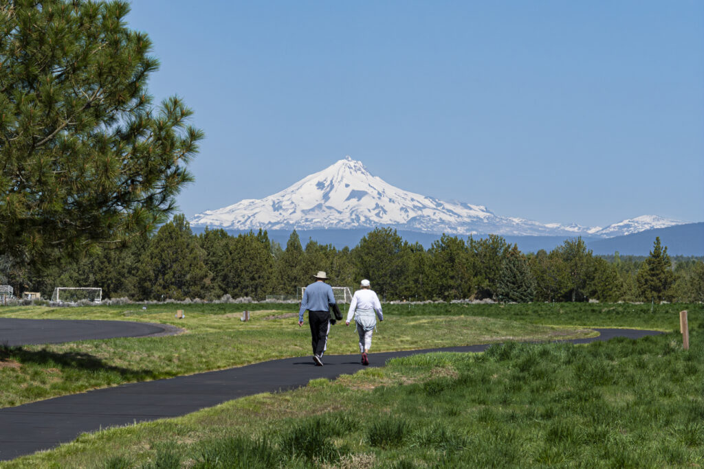 Couple wakling on a path with view of mountain cover in snow