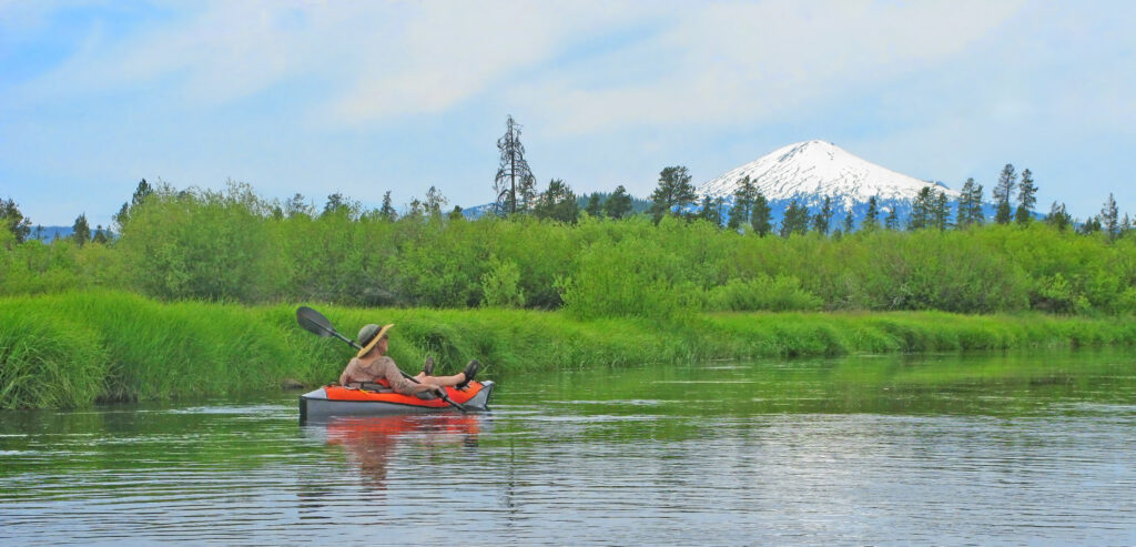 Kayaker floating the Deschutes River in Central Oregon