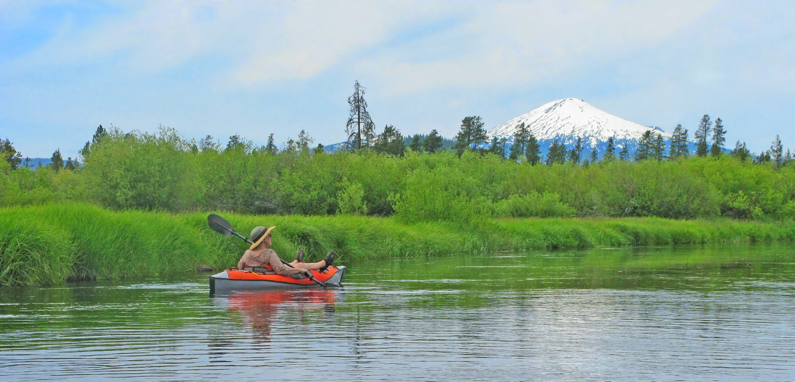 Kayaker floating the Deschutes River in Central Oregon